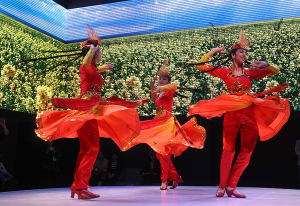 Dancers of China's Uygur ethnic group perform in the Xinjiang Pavilion at the 2010 World Expo in Shanghai, east China, May 5, 2010. (Xinhua/Zhao Ge)