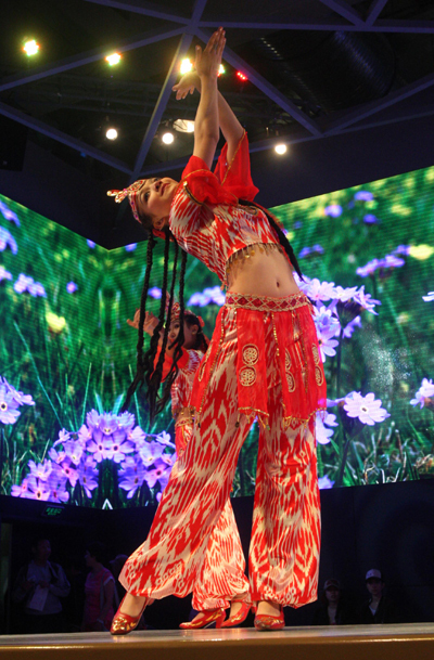 Dancers of China's Uygur ethnic group perform in the Xinjiang Pavilion at the 2010 World Expo in Shanghai, east China, May 5, 2010. (Xinhua/Zhao Ge)