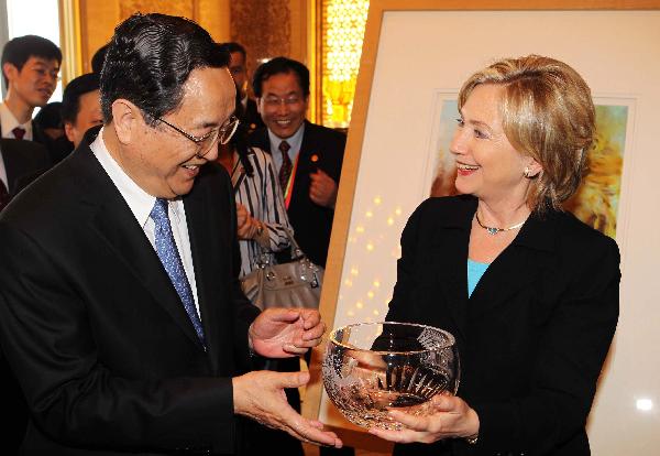 U.S. Secretary of State Hillary Clinton presents a gift to Yu Zhengsheng (L), member of the Political Bureau of the Communist Party of China (CPC) Central Committee and secretary of the CPC Shanghai Municipal Committee, during her visit to the Shanghai World Expo Park in Shanghai, east China, on May 22, 2010. U.S. Secretary of State Hillary Clinton presents a gift to Yu Zhengsheng (L), member of the Political Bureau of the Communist Party of China (CPC) Central Committee and secretary of the CPC Shanghai Municipal Committee, during her visit to the Shanghai World Expo Park in Shanghai, east China, on May 22, 2010.