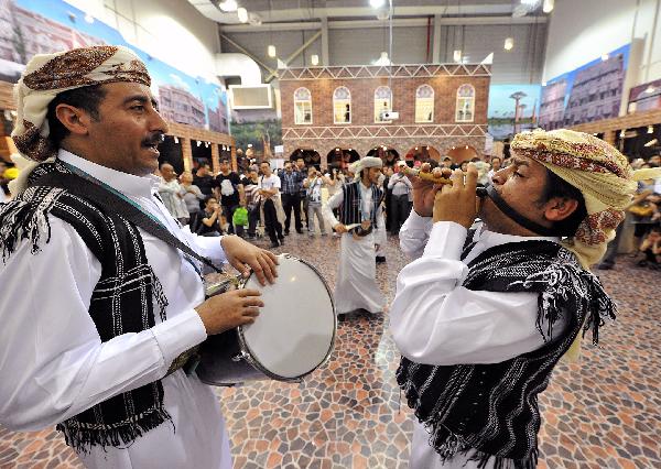 Yemeni performers dance along the drumbeat in Yemen Pavilion during the 2010 World Expo in Shanghai, east China, June 2, 2010. 
