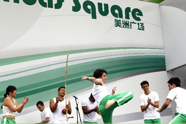 Actors perform Capoeira dance on the America Square during the national pavilion day of the Brazil Pavilion in the World Expo in Shanghai, east China, on June 3, 2010. A typical performance of Capoeira, a special dance form between dancing arts and martial arts, is held here by actors from China and Brazil to present the most important cultural symbol of Brazil on Thursday. (Xinhua/Liu Ying) 